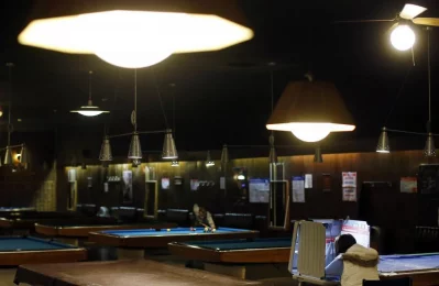 A voter sits in a voting booth at a billiards hall used as a polling station in Chicago. Photo: Jim Young