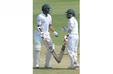 Bangladeshs captain Mushfiqur Rahim (R) and Shakib Al Hasan talk on the third day of a solo Test match between India and Bangladesh at the Rajiv Gandhi International Cricket Stadium in Hyderabad on February 11, 2017/AFP PHOTO 