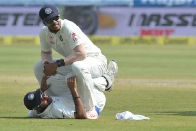 Indias Umesh Yadav (top) helps Bhuvneshwar Kumar stretch after the first innings on the fourth day of a solo Test match between India and Bangladesh at the Rajiv Gandhi International Cricket Stadium  on February 12, 2017 AFP