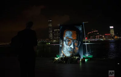 A man pays tribute to late Chinese Nobel Peace laureate Liu Xiaobo at a downtown park against Victoria Habour in Hong Kong, Wednesday, July 19, 2017. On the seventh day after Chinese Nobel Peace laureate Lius death, a day of significance in Chinese mourning rituals, his wifes whereabouts were unknown and her apartment complex remained under a security lockdown, while supporters congregated around the world to mark his passing in their own waysrnrnAP