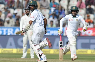 Bangladeshs captain Mushfiqur Rahim (R) and Mehedi Hasan run between the wickets on the third day of the only Test match between India and Bangladesh at the Rajiv Gandhi International Cricket Stadium in Hyderabad on February 11, 2017/AFP PHOTO 