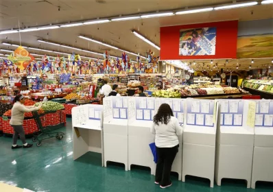 A woman votes at a polling station inside a local grocery in National City, California. Photo: Mike Blake