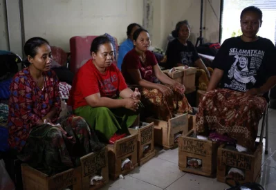 In this March 19, 2017 photo, women from Kendeng, Central Java whose feet are encased in concrete in protest against the operation of a cement factory in Kendeng, Central Java, rest at their temporary shelter at the Legal AId Institute office in Jakarta, IndonesiarnrnAP