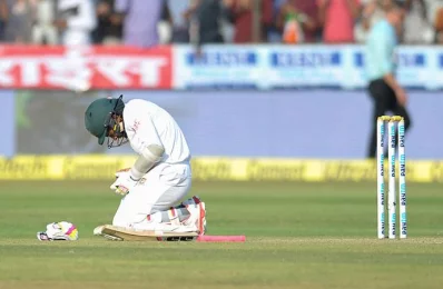 Bangladeshs captain Mushfiqur Rahim sits on the ground after the ball hit his fingers bowled by Indias Ishant Sharma on the third day of the only Test match between India and Bangladesh at the Rajiv Gandhi International Cricket Stadium in Hyderabad on February 11, 2017/AFP PHOTO 