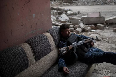 A Federal Police soldier lays on a couch before moving to a front line near the old city during fighting against Islamic State militants on the western side of in Mosul, Iraq, Tuesday, March 28, 2017rnrnAP