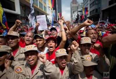 Government supporters and militia march in a rally against the United States and to reject the possible sanctions that the Organization of American States, OAS, could apply to the government of Venezuela, in Caracas, Venezuela, Tuesday, March 28, 2017. Diplomats from across the Western Hemisphere are meeting to determine whether to punish Venezuelas socialist government for violating the countrys democratic orderrnrnAP