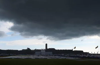 Sri Lankan groundstaff bring on covers to protect the field from rain during the third day of the opening Test cricket match between Sri Lanka and Bangladesh in Galle on March 9, 2017/AFP PHOTOrn
