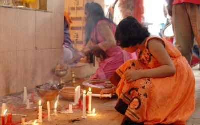 A young devotee lights candles at Dhakeshwari temple | Focus Bangla