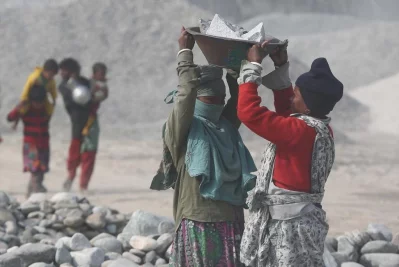 A female worker helping another out with lifting some of the crushed stones | Syed Zakir Hossain/Dhaka Tribune