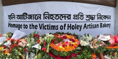 People pay homage to the victims of Holey Artisan terrorist attack on its one year anniversary by laying garlands on the bakeryu2019s doorsteps. Photo- SYED ZAKIR HOSSAIN/DHAKA TRIBUNErn