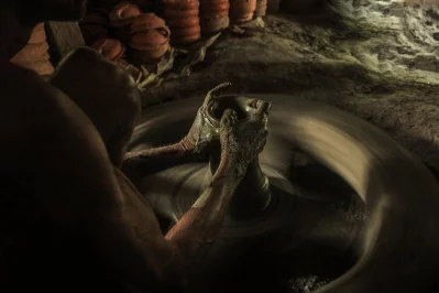 A potters hands shape clay on the pottery wheel | Photo: Zahidur Rahman