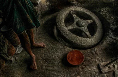 A pottery wheel lies at the feet of a potter | Photo: Zahidur Rahman