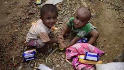 Two Rohingya children scramble over a cucumber to quench their thirst as the day gets hotter and water becomes scarcer | Mahmud Hossain Opu/Dhaka Tribune