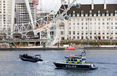 Police boats pass the London Eye as they patrol on the River Thames, near to the Houses of Parliament in Westminster, central London on March 22, 2017, during an emergency incident AFP