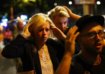 People leave the area with their hands up after an incident near London Bridge in London, Britain June 3, 2017/REUTERS