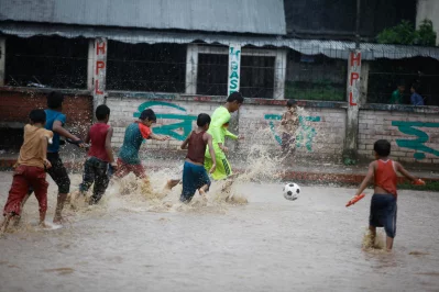 Children play football in the rain  | Mahmud Hossain Opu