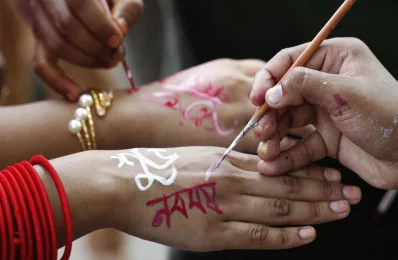 As part of the celebrations, several messages and designs are drawn on peoples hands and faces | Mehedi Hasan/Dhaka Tribune
