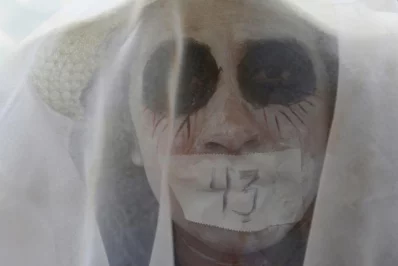 A woman takes part in a performance to protest against the disappearance of the 43 students of Ayotzinapa College Raul Isidro Burgos in Guerrero, in Mexico City, MexicornrnREUTERS