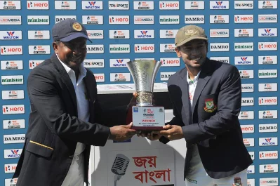 Sri Lankan Test captain Rangana Herath (L) and Bangladesh Test captain Mushfiqur Rahim pose for photographers with the series trophy at the start of the first day of the opening Test match between Sri Lanka and Bangladesh at the Galle International Cricket Stadium in Galle on March 7, 2017 AFP 