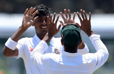 Bangladesh cricketer Mustafizur Rahman (L) celebrates with teammate Mehedi Hasan after he dismissed Sri Lankan batsman Rangana Herath during the second day of the opening Test cricket match between Sri Lanka and Bangladesh at The Galle International Cricket Stadium in Galle on March 8, 2017 AFP