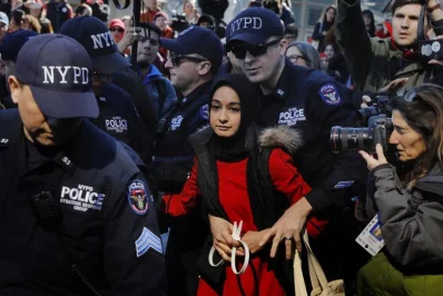 New York Police Department officers arrest a woman who was taking part in a Day Without a Woman march on International Womens Day in New YorkrnrnREUTERS