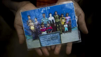 Rohingya Mubarak Begum, who crossed over from Myanmar into Bangladesh, holds a photograph of her family members, in Kutupalong, Bangladesh, on Friday, September 8, 2017. Mubarak says the government took pictures of Rohingya families annually to track their numbers. Her daughter Rubina Begum was not able to make the crossing with them and still in Maungdaw AP