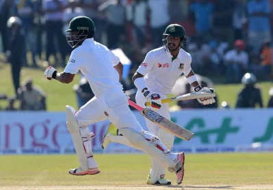 Bangladesh cricketers Soumya Sarkar (R) and Tamim Iqbal (L) run between the wickets during the second day of the opening Test cricket match between Sri Lanka and Bangladesh at The Galle International Cricket Stadium in Galle on March 8, 2017 AFP
