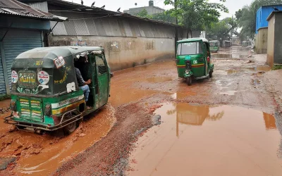 Vehicles ply on water-filled potholed roads, as the development project promises to be implemented in two years | Focus Bangla