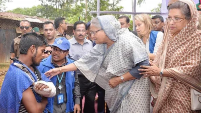 The prime minister sympathises with a Rohingya man who has an injury on his left hand at Kutupalong Rohingya camp on September 12, 2017 | Focus Bangla