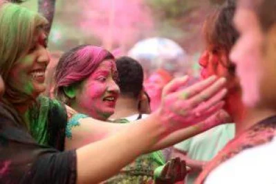 Devotees paint themselves with color dye and vermilion. Photo: Dhaka Tribune/Syed Zakir Hossain