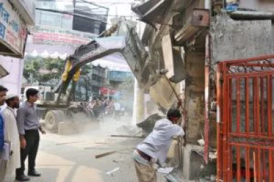 Workers with sledgehammers, commissioned by the Rajdhahi Unnayan Kartipakkha (RAJUK), demolished several illegal structures in Mirpuru2019s Kazipara area on Wednesday, November 23, 2016, in an effort to discourage people not to construct structures that violate rules. A digger is at the background SYED ZAKIR HOSSAIN/DHAKA TRIBUNE