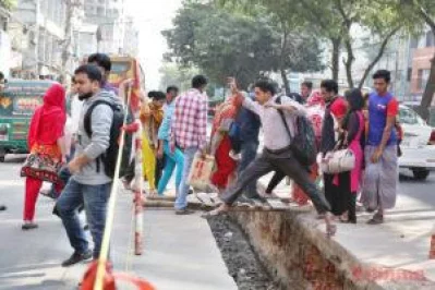 On-foot Dhaka commuters hop across a dig, created for Metro Rail construction, on a regular basis, knowing very well one sudden slip may cause them serious injuries. The photo was taken on Wednesday, November 23, 2016 SYED ZAKIR HOSSAIN/DHAKA TRIBUNE
