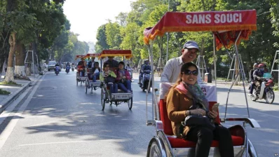 Tourists ride rickshaws for sightseeing in Hanoi, Vietnam.