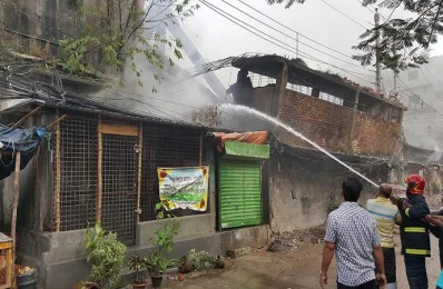 A firefighter seen dousing the flames opposite the DNCC Kitchen market COLLECTED 