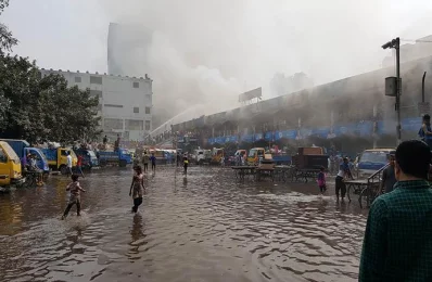 Firefighters battle the fire on the northern side of the DNCC market as onlookers stare in agony COLLECTED 