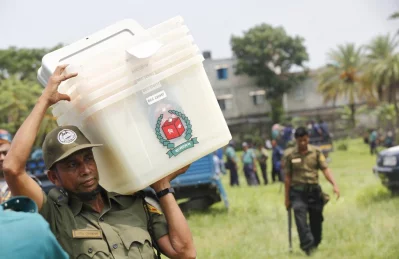 An Ansar member carries the ballot boxes to the polling stations | Mehedi Hasan/Dhaka Tribune