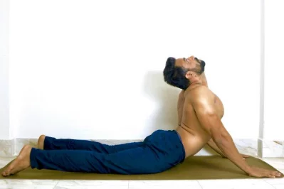 Cobra pose - This gentle backbend stretches your abdomen, chest and shoulders and strengthens your spine. It also helps to relieve stress and fatigue that can accompany back pain. nnLie on your stomach with your hands under your shoulders and fingers facing forward and draw your arms in tightly to your chest, donu2019t allow your elbows to go out to the side. Now inhale and press into your hands to slowly lift your head, shoulder, and chest. You can lift partway, halfway or all the way up, depending on your flexibility. Hold for 1-2 minutes and breathe normally. Now exhale and release your chest, shoulders and head. Bring your arms by your side and rest for 30 seconds.