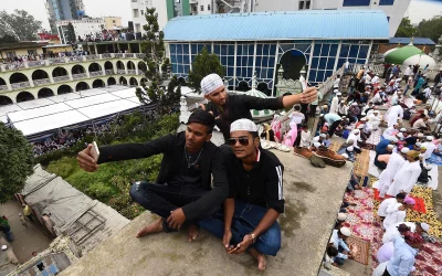 Nepali Muslims youth taking picture before offering Eid prayers at the start of the Eid al-Fitr holiday marking the end of Ramadan at the Kashmiri Mosque in Kathmandu on June 16, 2018 | AFP