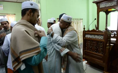 Thai Muslim men greet each other after Eid al-Fitr prayers at a mosque in Thailands southern Narathiwat province on June 15, 2018 | AFP