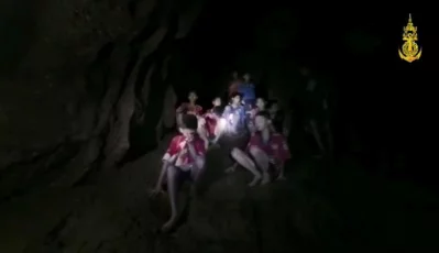 Boys from an under-16 soccer team and their coach wait to be rescued after they were trapped inside a flooded cave in Chiang Rai, Thailand | Thai Navy Seal Facebook via Reuters