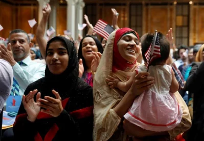 New citizens smile at a US Citizenship and Immigration Services (USCIS) naturalization ceremony at the New York Public Library in Manhattan | Reuters