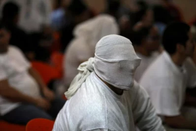 A person deported from the US waits to be processed at an immigration facility in San Salvador, El Salvador | Reuters