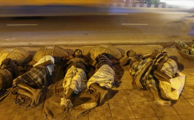 At late hours when the fortunate are sleeping peacefully on comfortable mattresses, thousands of homeless people sleep in the streets of Dhaka city. In this picture labourers are seen sleeping on a footpath only using their baskets as the head-rest in Kawran Bazar area.