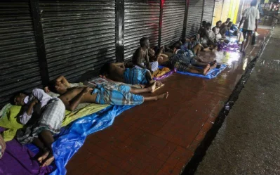 There is no 9-5 shift for these people as they work through the night, interrupted only by rain. The labourers pack up their belongings to seek refuge on the pavement in Panthapath, with closed shutters to their backs and an uncaring but accommodating roof over their heads.