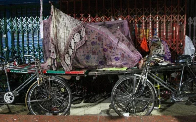 While one of them may afford to sleep unconcerned about pests, another may as well use the night air as a blanket and the insectsu2019 buzzing as lullaby. The owners of parked rickshaw-vans that become makeshift beds do not know of their nightly tenants, and the erstwhile sleepers do not know the owners. Each night, a different bed; each night, a different shelter.