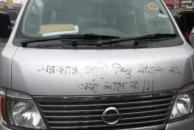 Protesting students vandalize a microbus in Shahbag and pose a statement that government vehicles may not need drivers to have licencesnMehdi Hasan/Dhaka Tribune