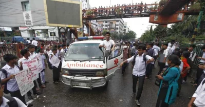 A student riding on an ambulance clears the road | Mehedi Hasan/Dhaka Tribune