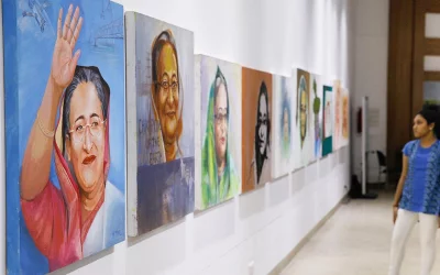 A visitor looks on a row of paintings depicting different stages of Sheikh Hasinas life Mahmud Hossain Opu/Dhaka Tribune