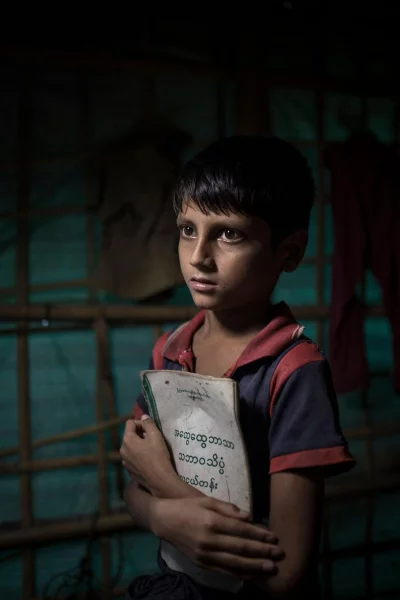 Mohammad Junaid, 11: I carried a couple of books with me because I want to read and write no matter where I am. I saw my village put on fire. It was painful by now we are safe. I study in a school in the camp. Ahmer Khan/Amnesty International