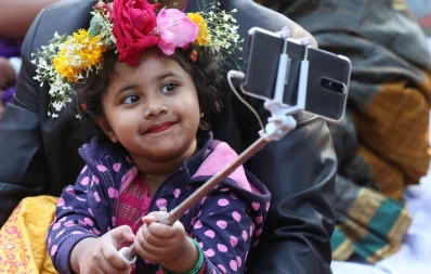 A child poses for a selfie during Pohela Falgun festivitiesu2014that mark the first day of spring in the Bangla month of Falgunu2014at Charukola, Dhaka University, on February 13, 2019 | Syed Zakir Hossain